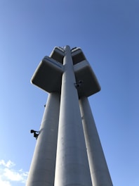 A modern tower structure against a clear blue sky.