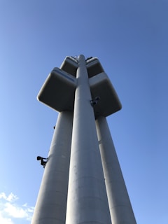 A newly constructed climbing tower standing tall against a clear blue sky.