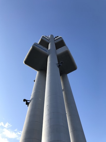 A modern tower structure against a clear blue sky.