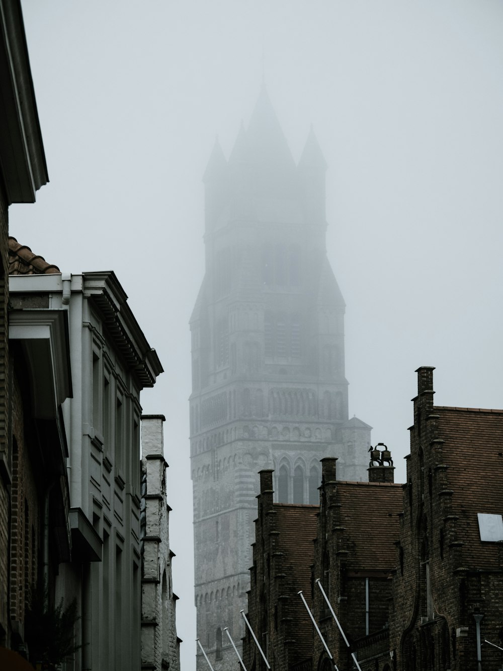 concrete buildings during foggy weather