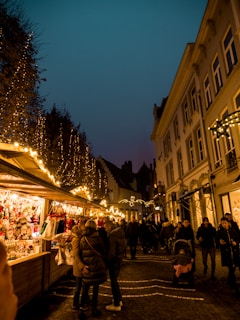 people walking on street with food stall at night