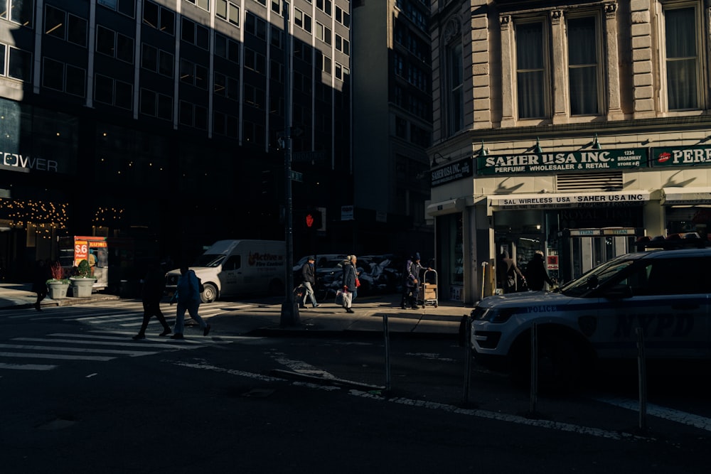 people crossing at pedestrian lane during daytime