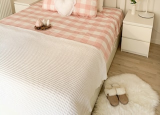 white and pink bed sheet