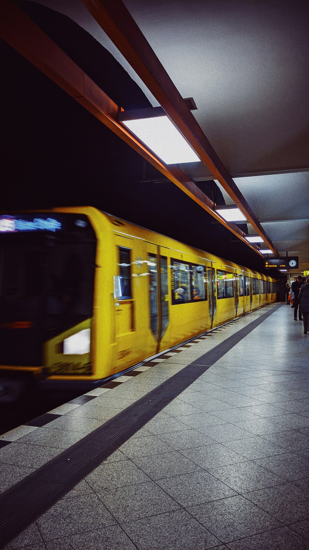 yellow train on station at night time