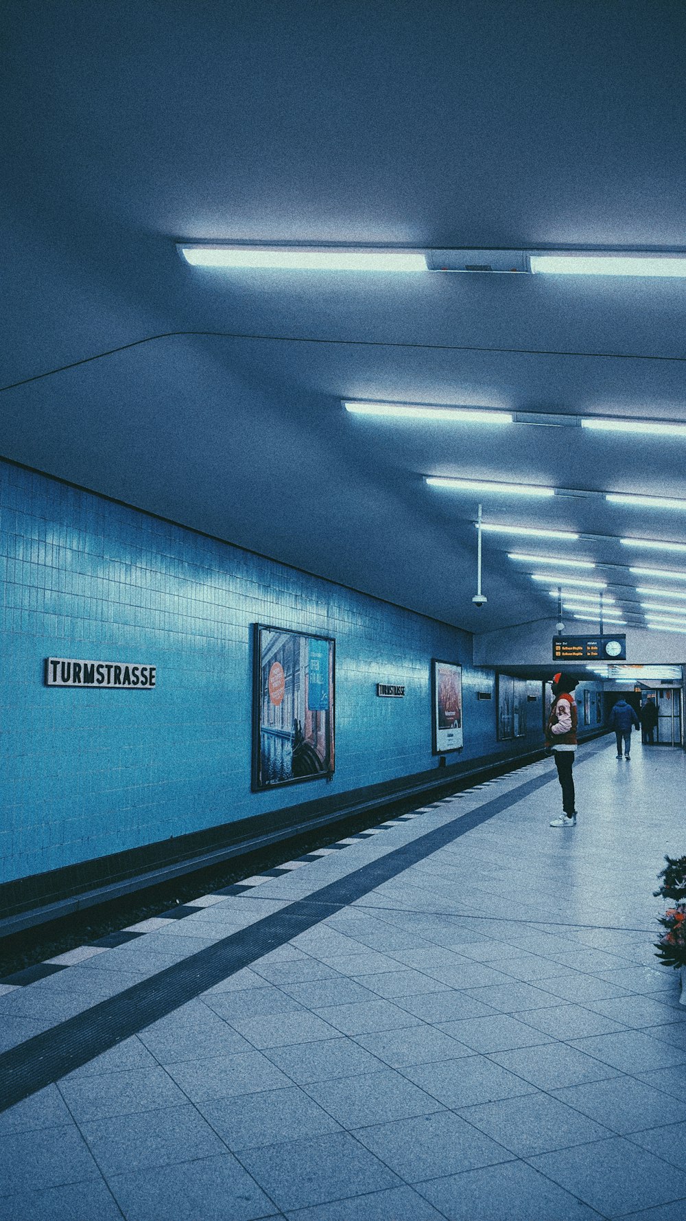 person at empty station with lights