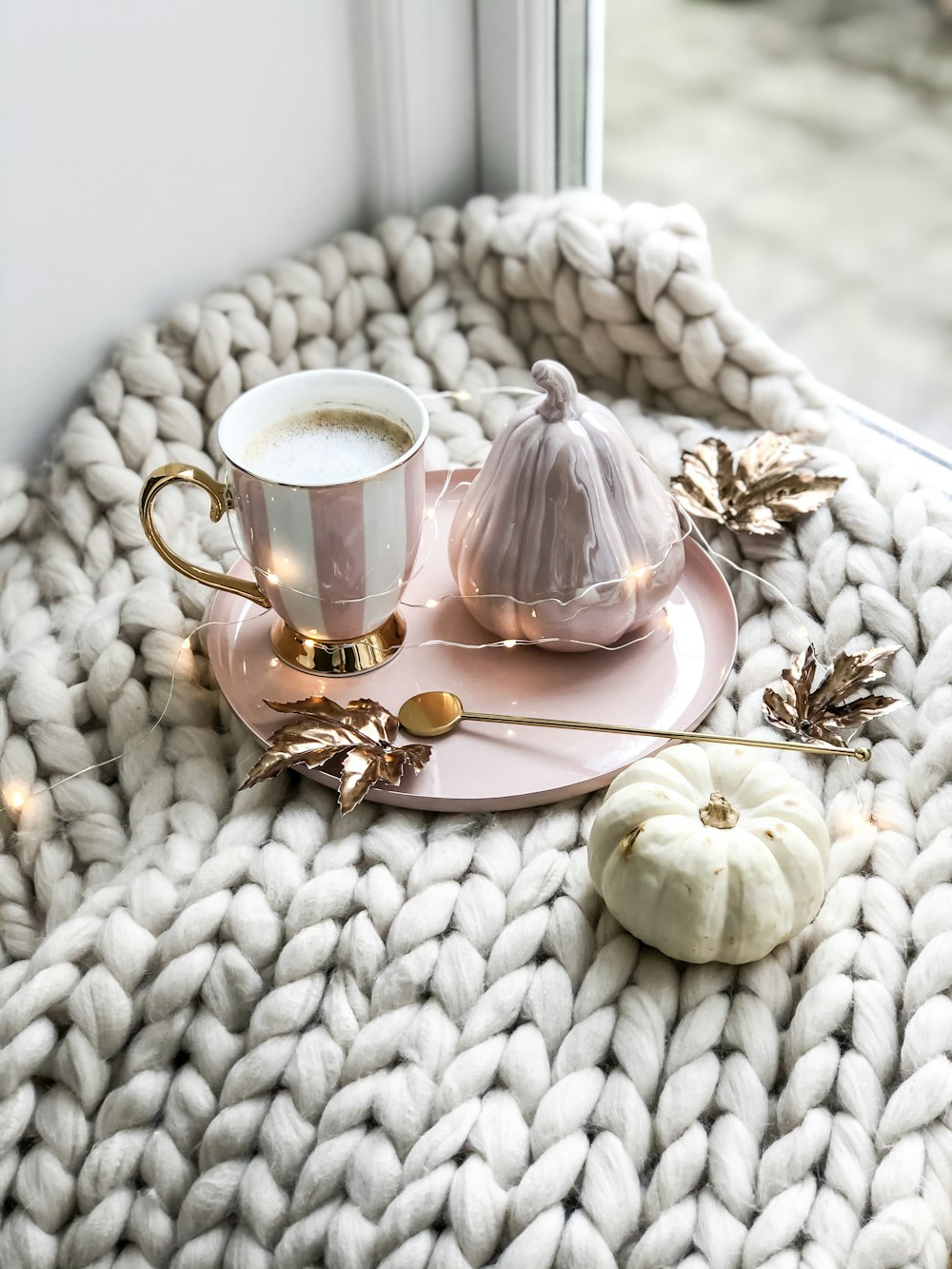 pink mug beside jar on tray