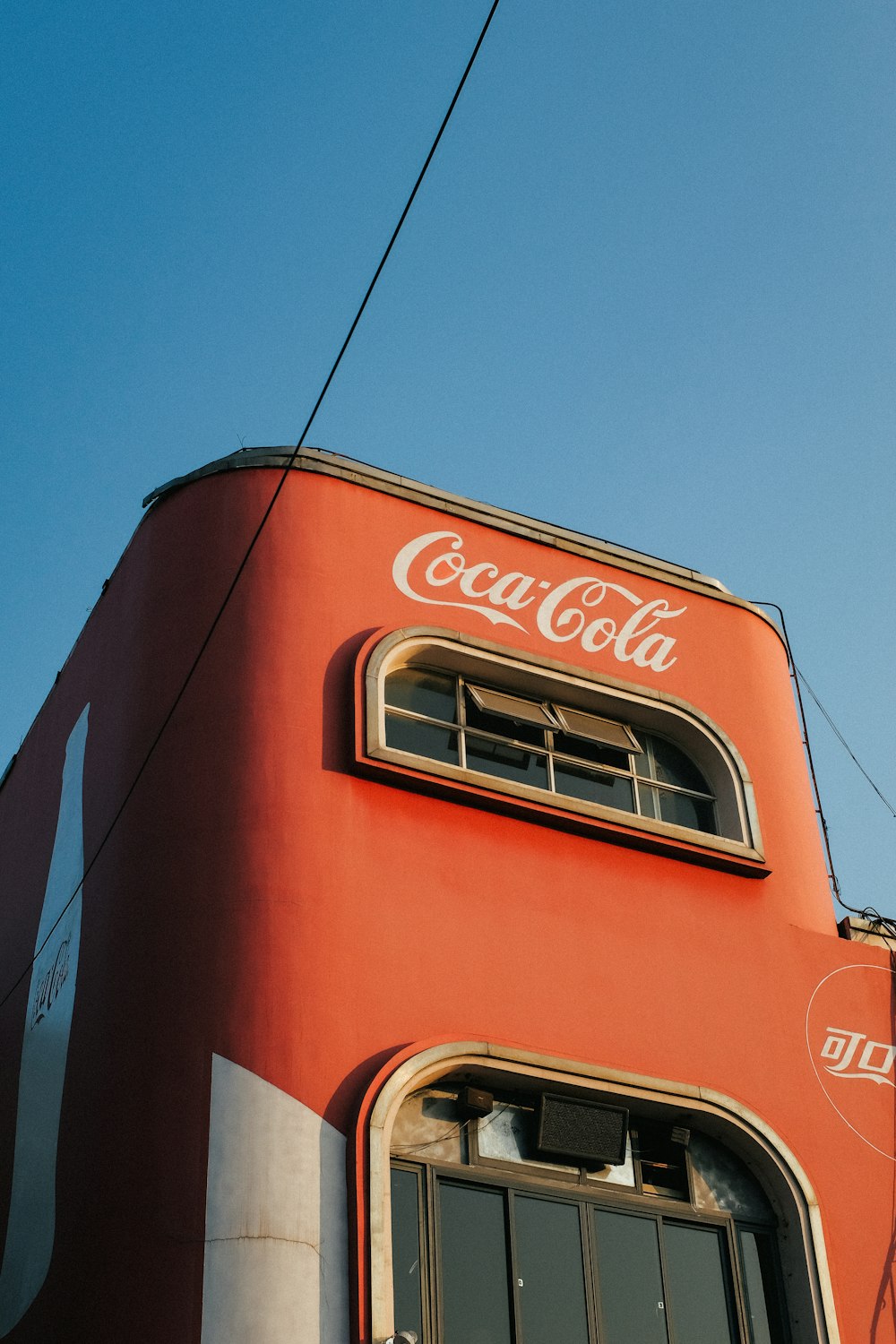 low-angle photography of Coca-Cola painted building