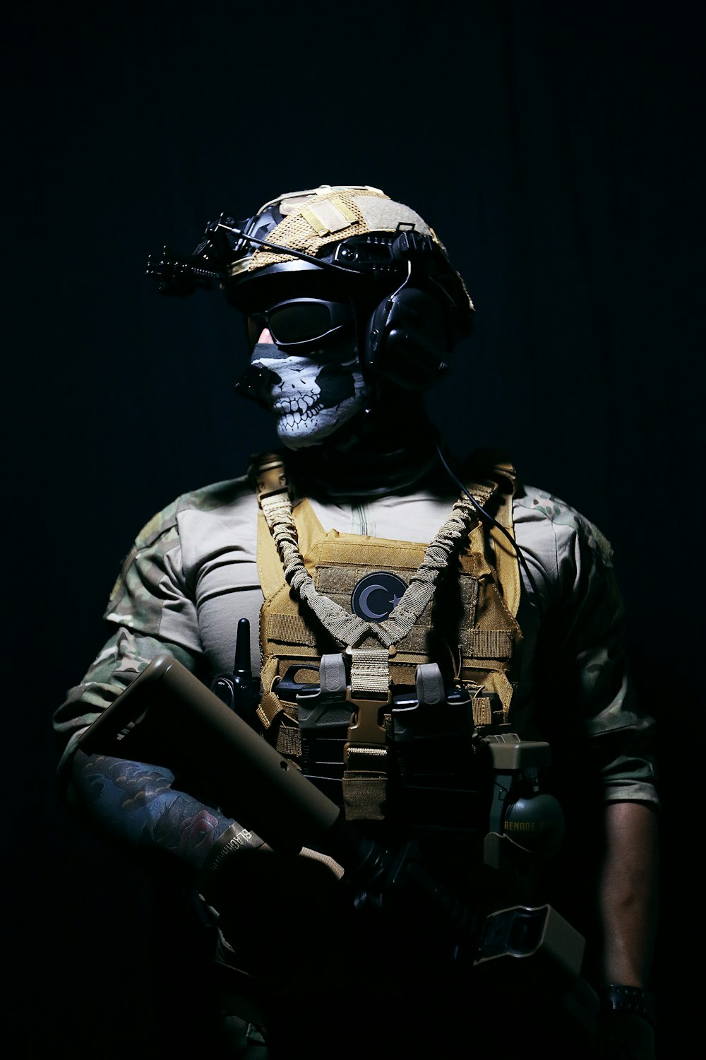 a man in a helmet and goggles holding a gun