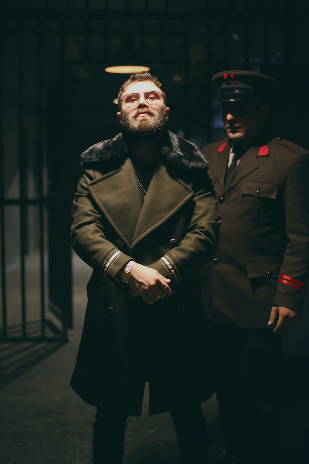 selective focus photography of standing man beside man in uniform