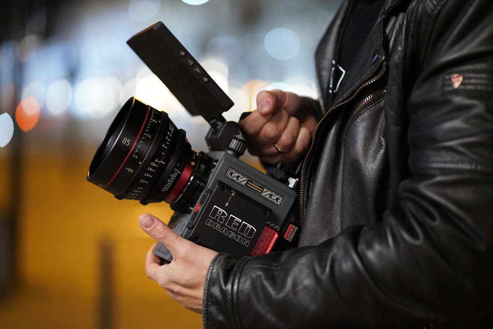 person holding black video camera