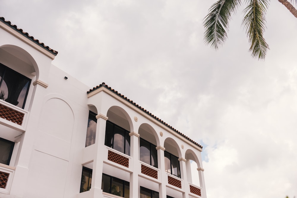 low-angle photography of white building under white sky