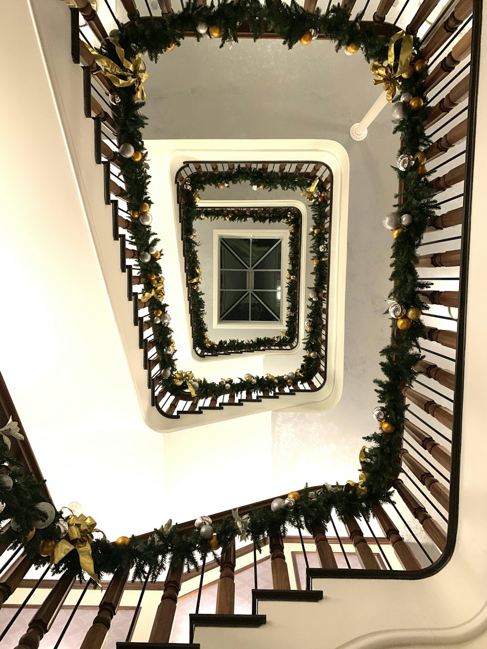 brown spiral stairs with Christmas decorations
