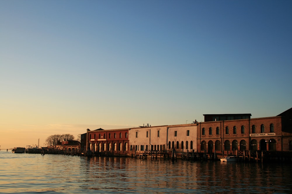 brown concrete building near the body of water