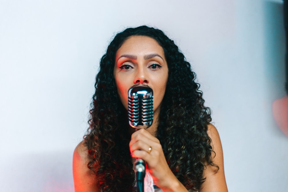 woman singing using condenser microphone