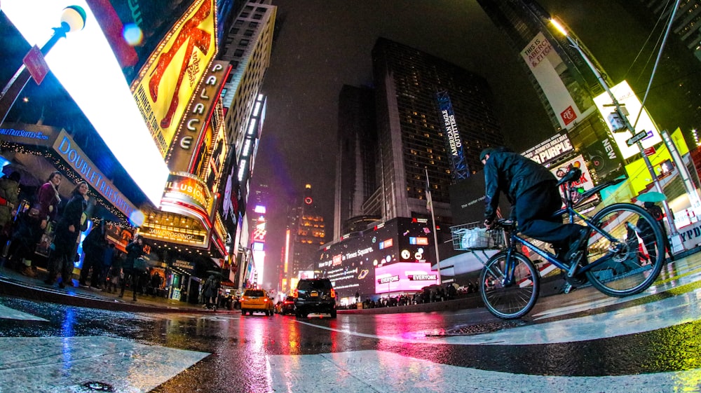 man riding bicycle on pedestrian lane