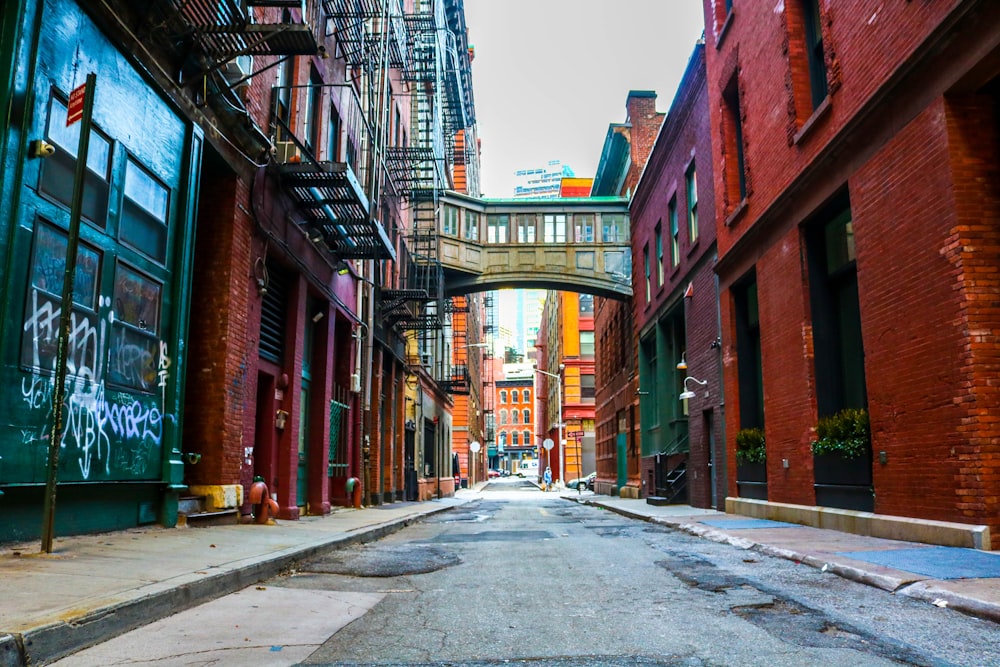 empty road between brown buildings during daytime