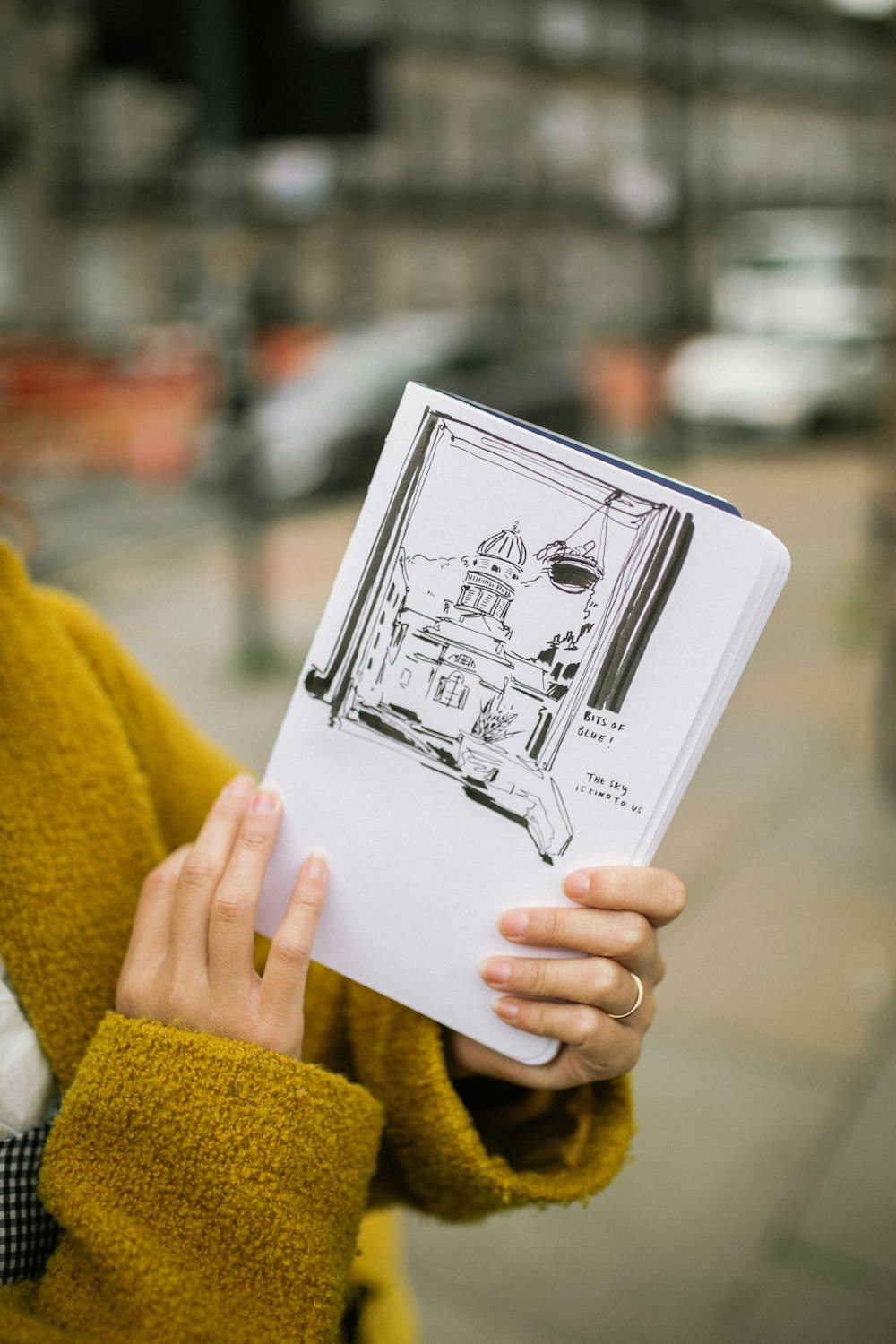 woman holding a white book