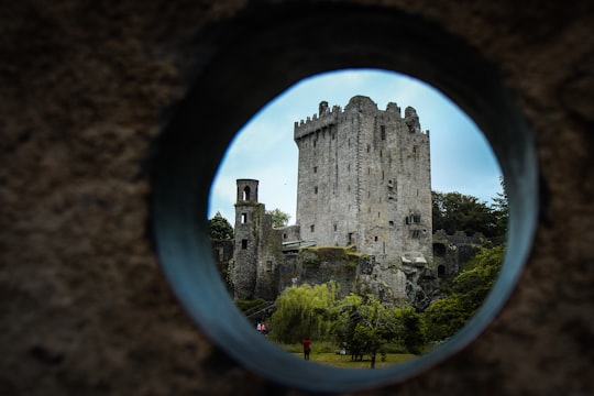 gray tower during day time in Blarney Stone Ireland