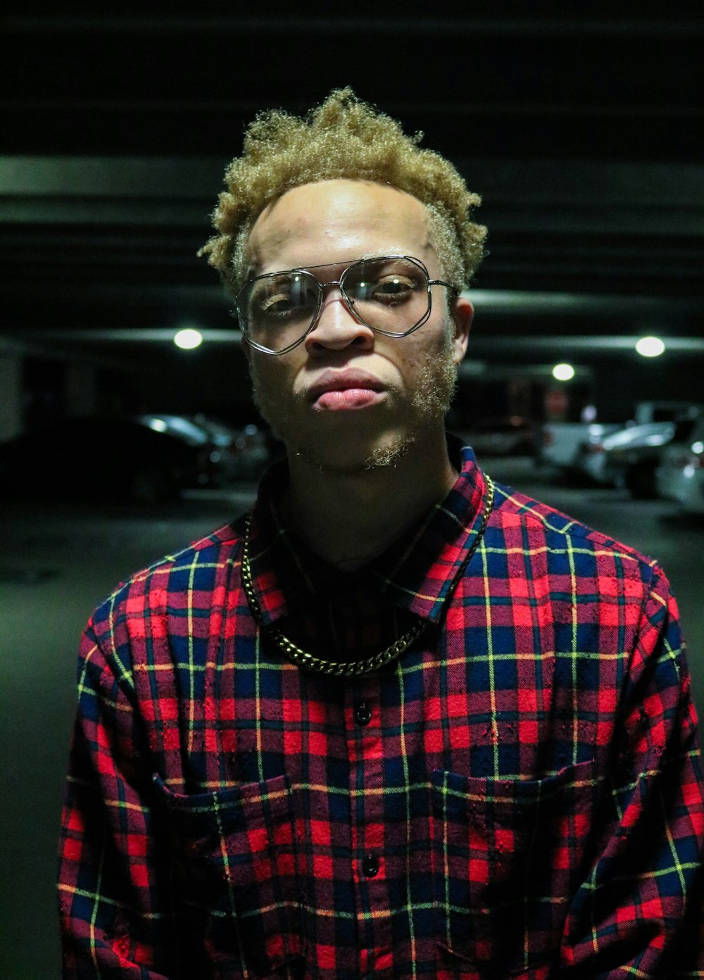 man in red, black, and yellow plaid sport shirt