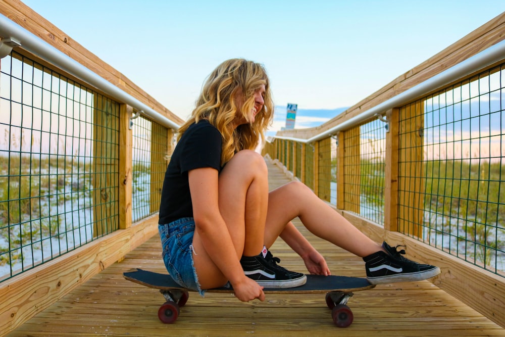 woman sitting on skateboard