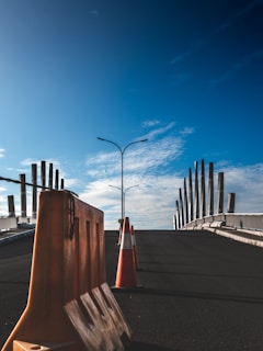 Concrete road barriers lined up in a desert construction site during sunset.