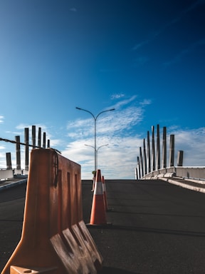 Concrete road barriers lined up in a desert construction site during sunset.