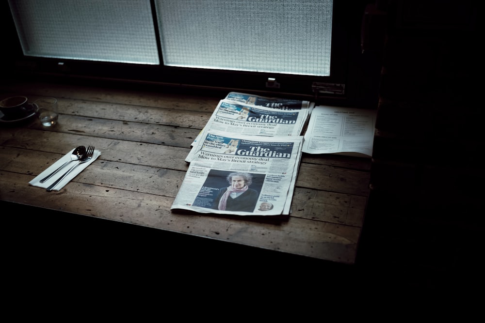 newspapers beside window