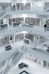 Modern minimalist library interior with soft blue-gray and green accents, evoking calm and focus.