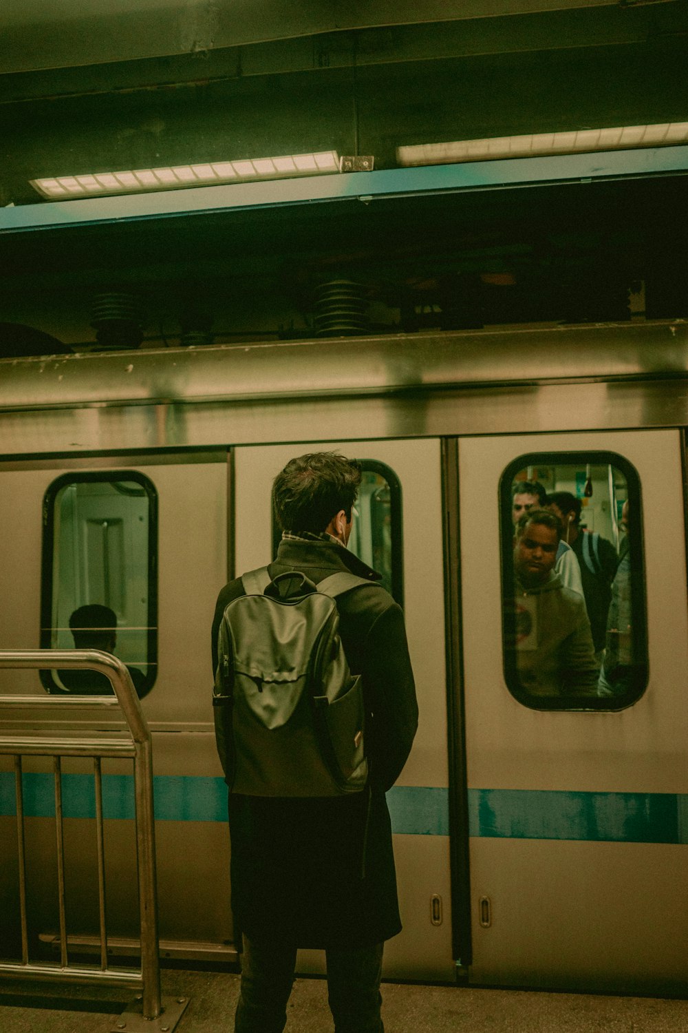 man standing in front of train door