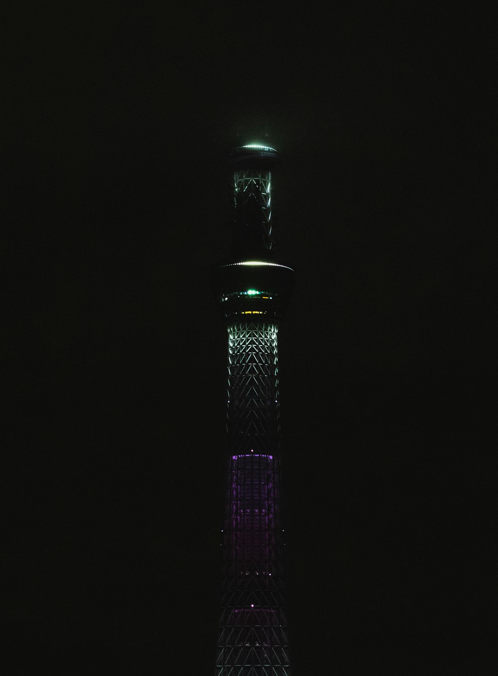a tall tower lit up in the dark