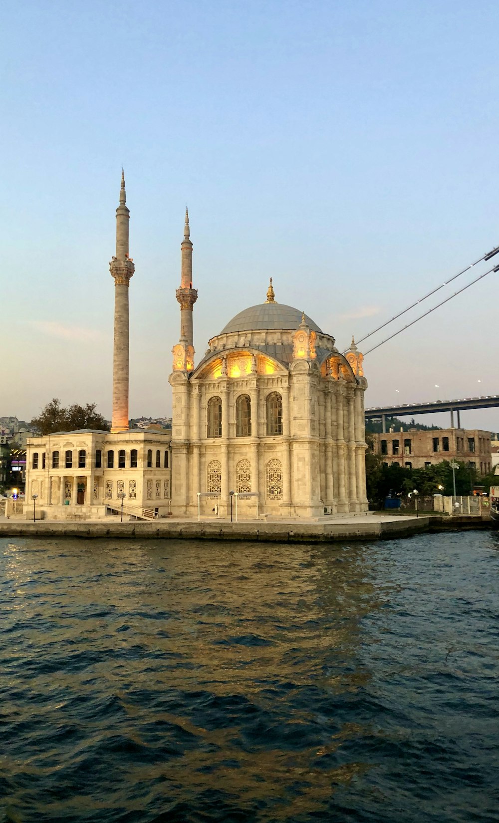 brown concrete dome building beside body of water