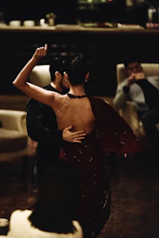 man and woman dancing indoors