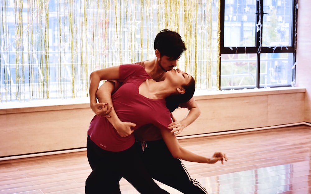 photography of dancing man and woman inside room