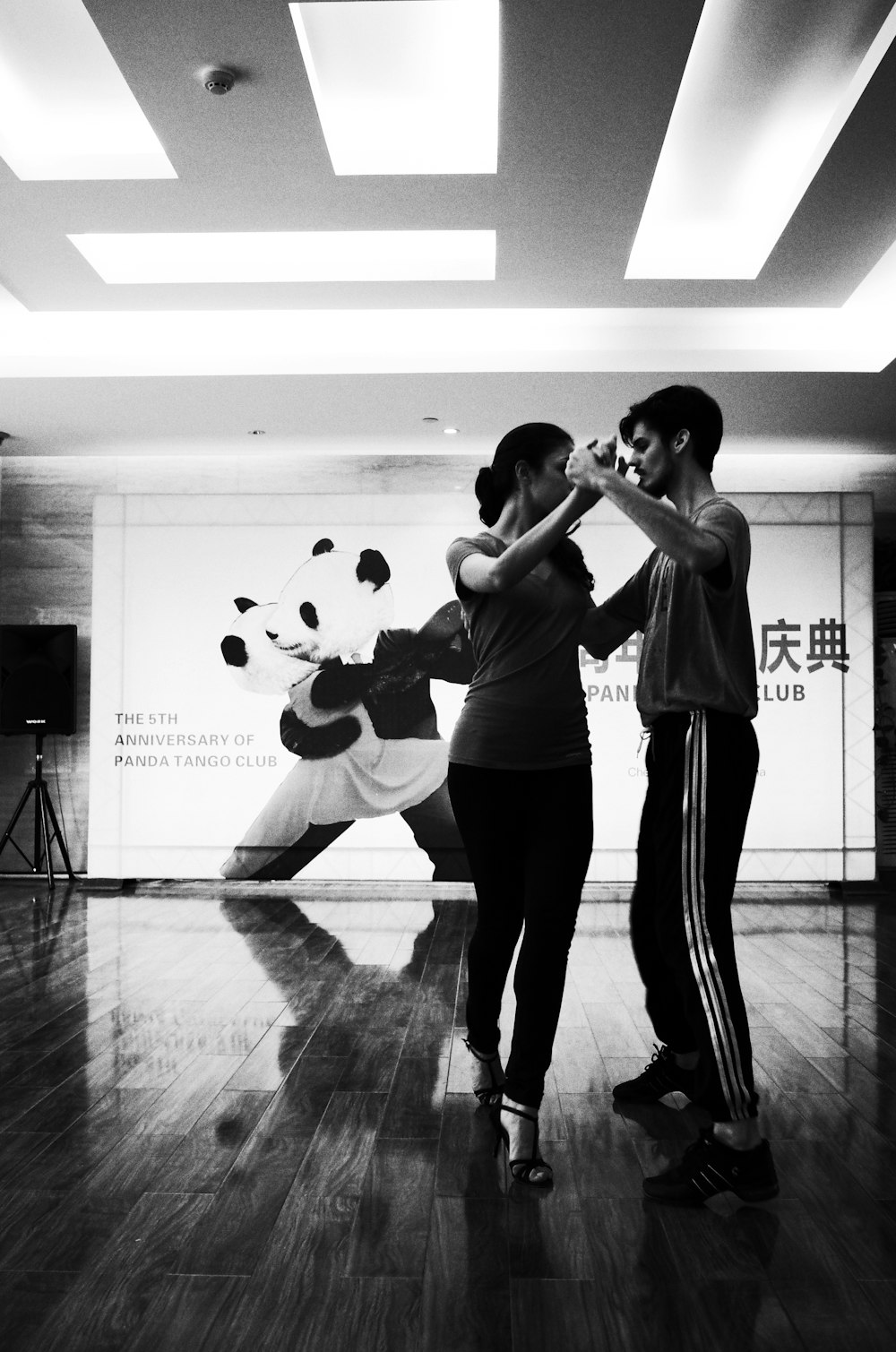 grayscale photo of dancing man and woman inside room