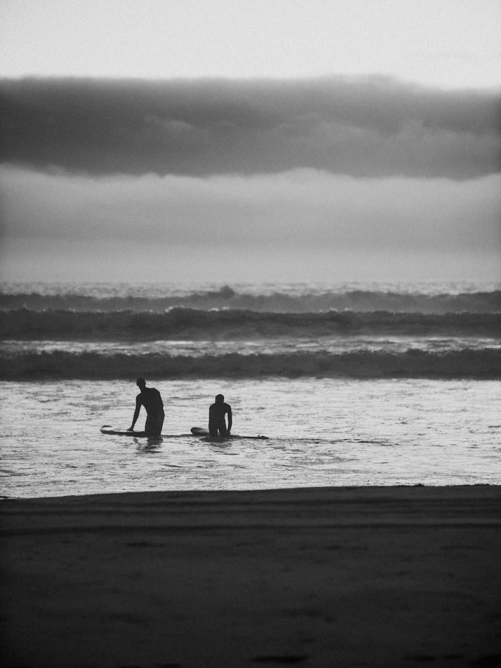 two man swimming on water