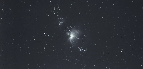 A vibrant photo of a community gathering under a starry blue nebula sky.