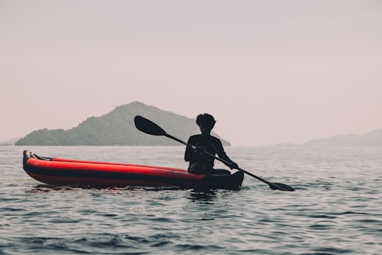 person riding red kayak in James Bond Island Thailand