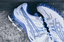 pair of white-and-purple Asics sneakers