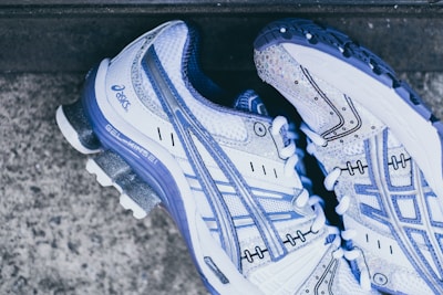 pair of white-and-purple Asics sneakers