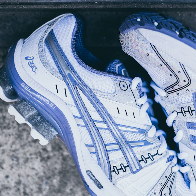 A pair of white and purple ASICS running sneakers