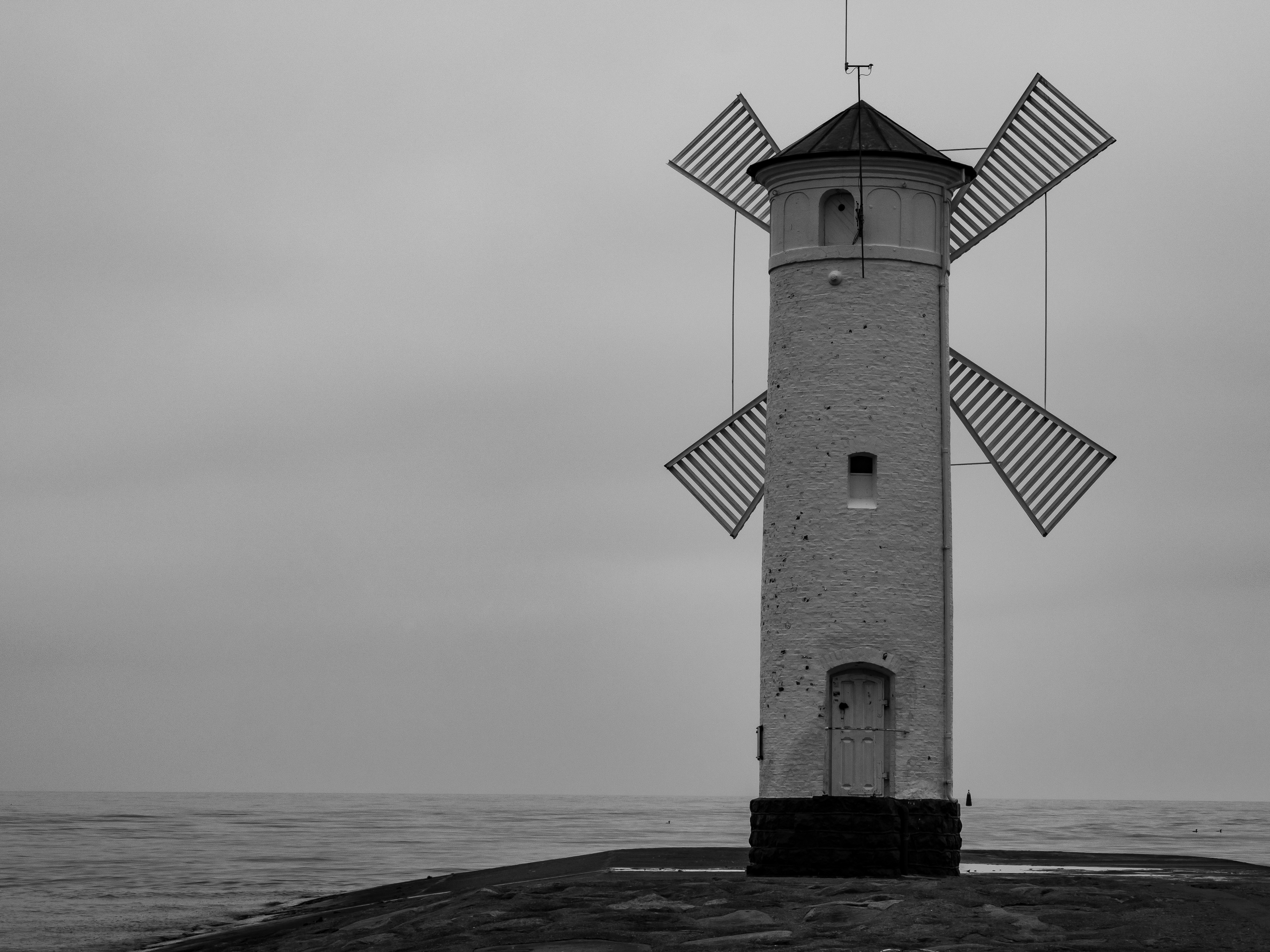 lighthouse near calm body of water