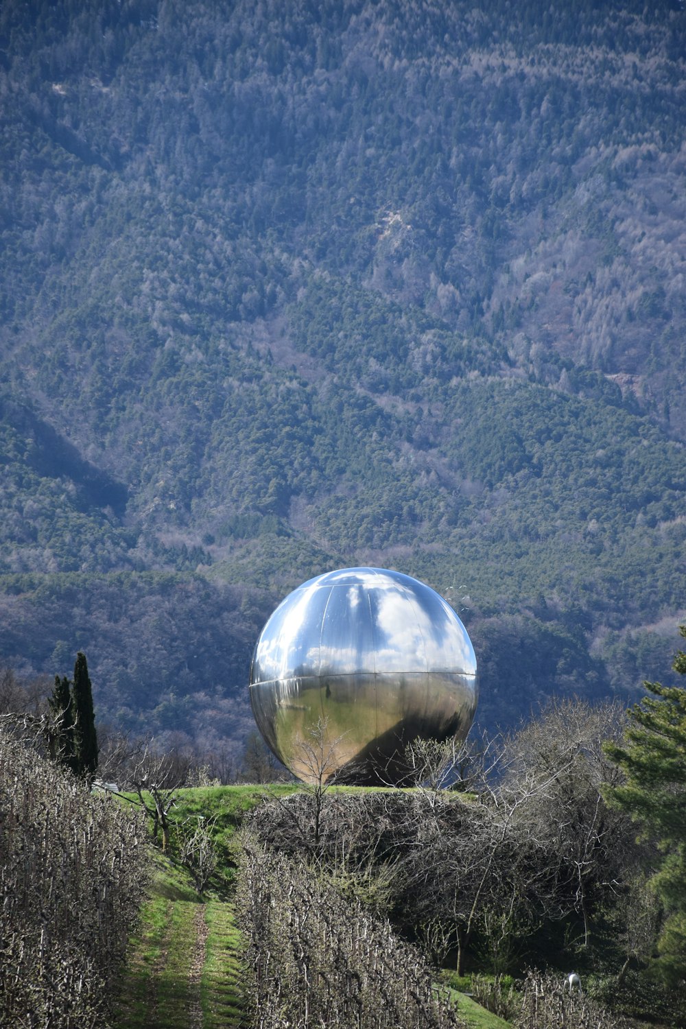 photography of ground gray sculpture on top of mountain during daytime