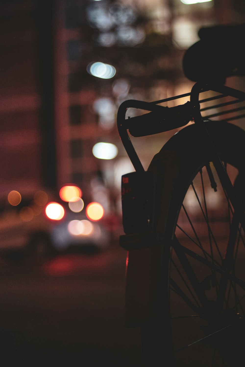 silhouette photo of bicycle with bokeh effect