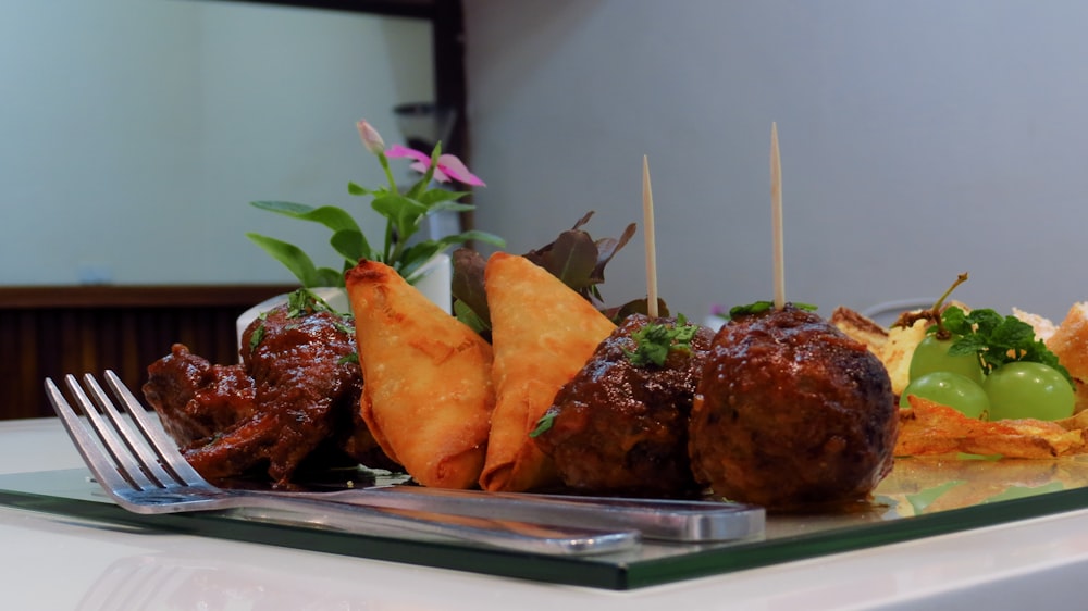 silver fork beside tray of food