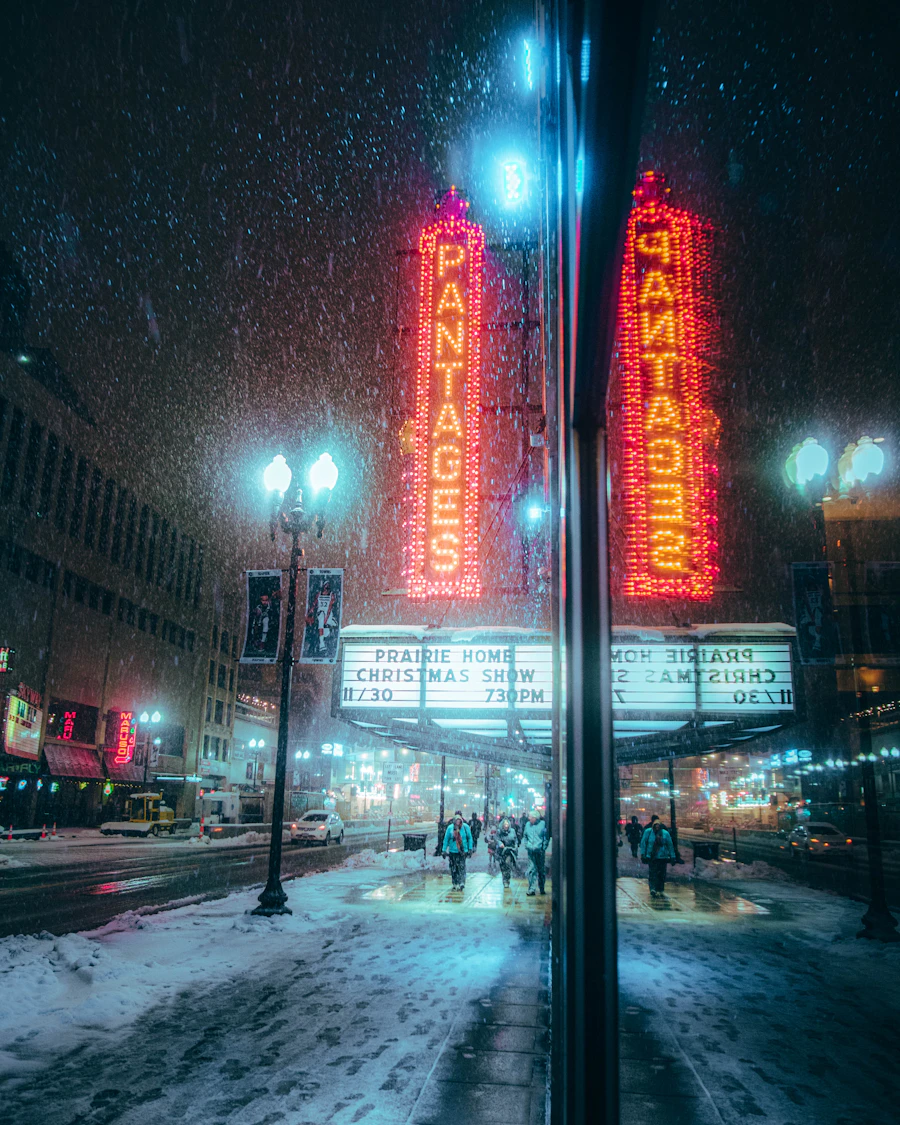 Neon theater signs on Hennepin Avenue on a snowy night