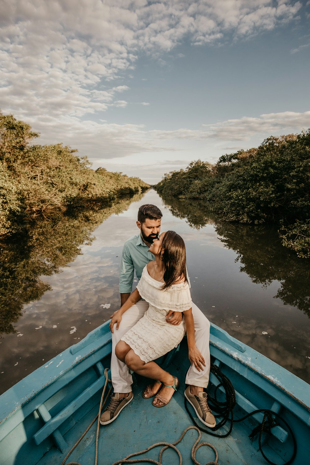 man and woman riding on brown canoe boat