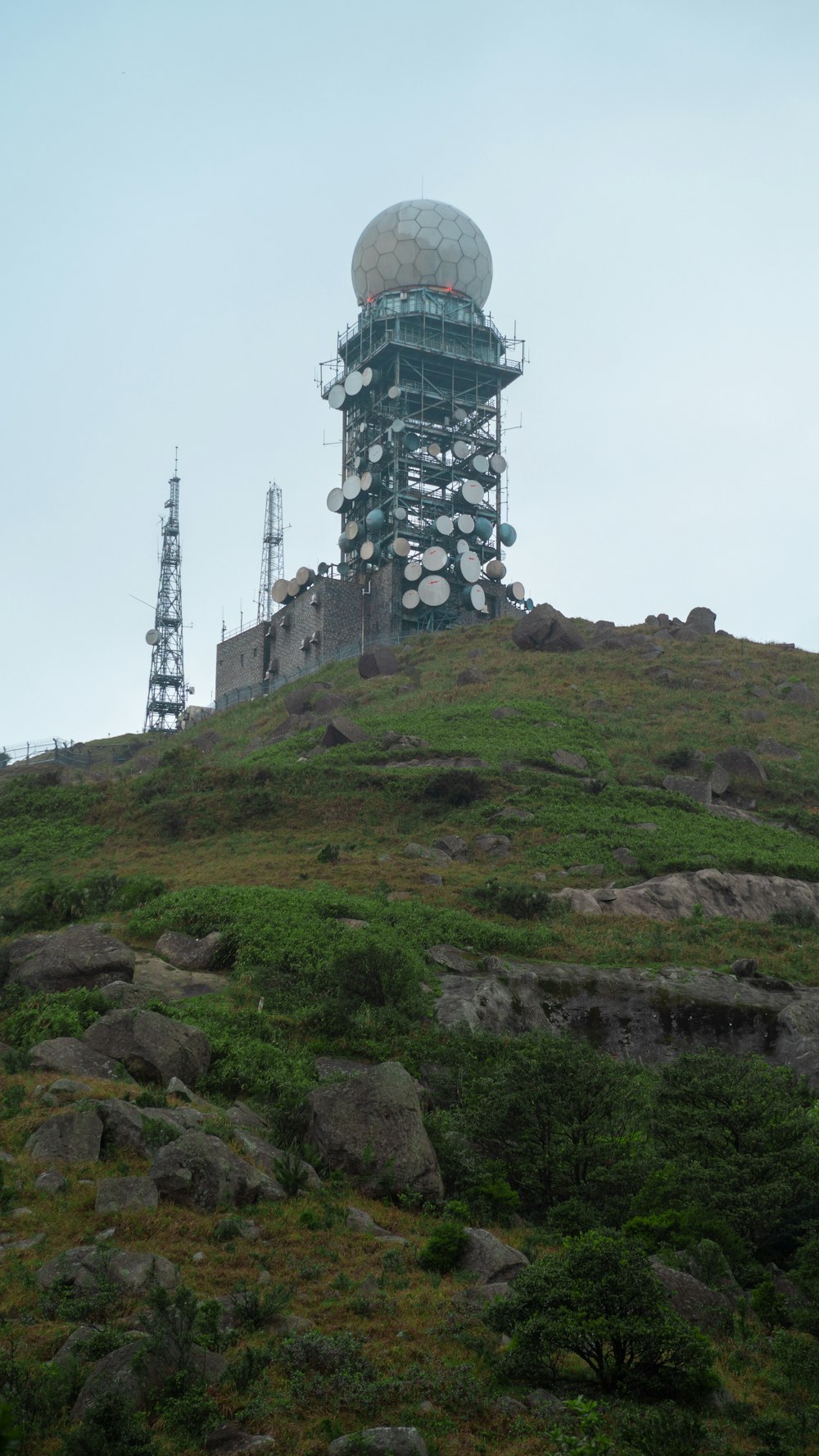 rectangular black and gray tower with round white dome