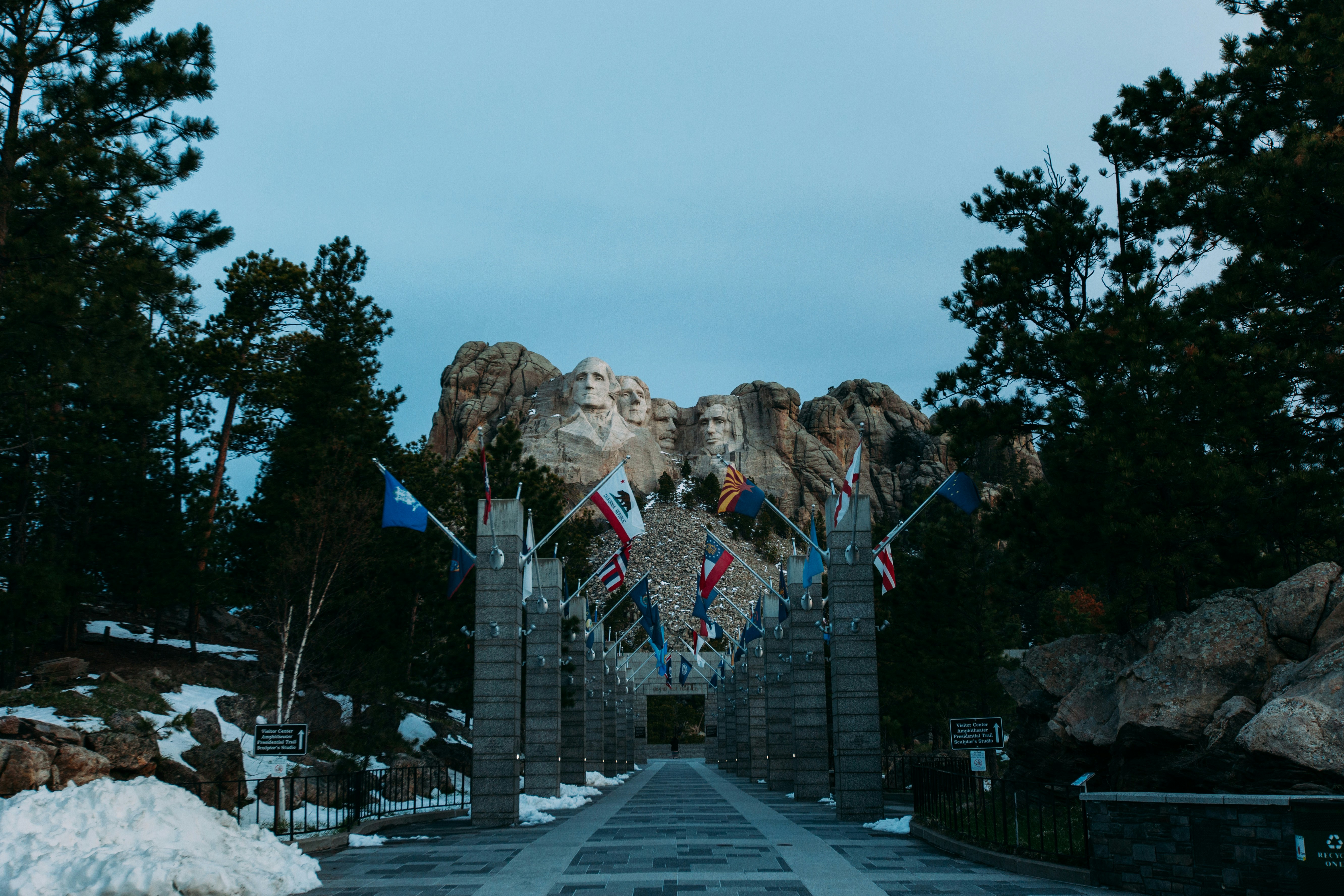 a road with flags and mountains in the background