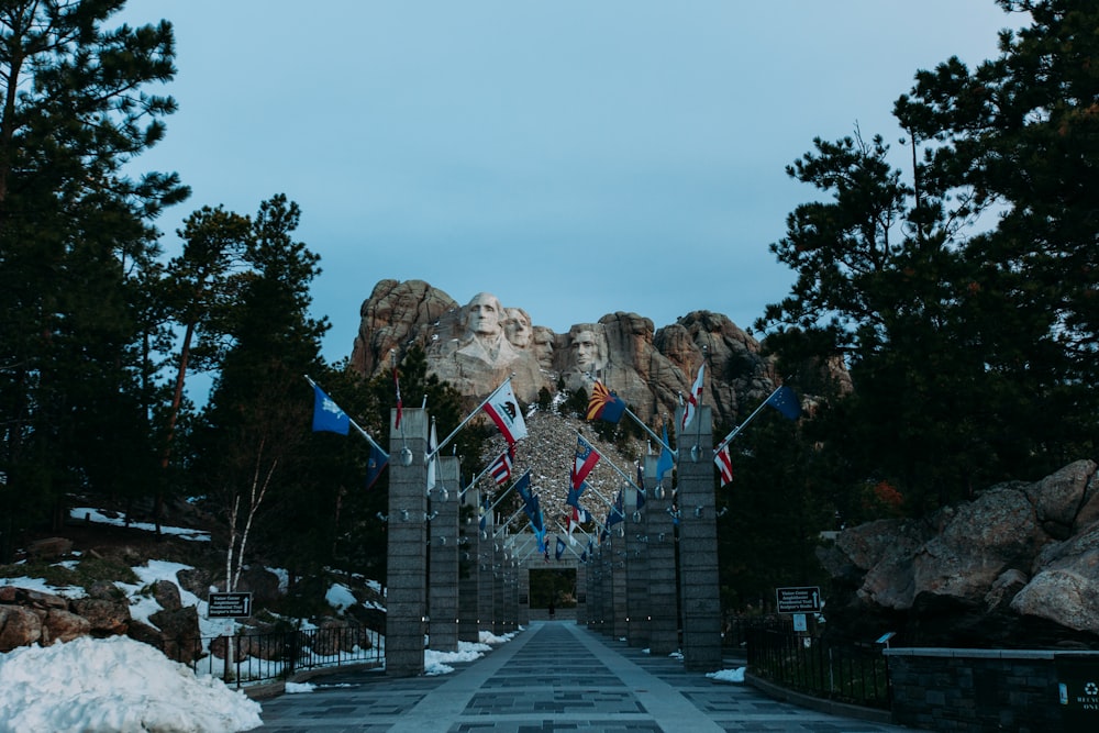 a road with flags and mountains in the background