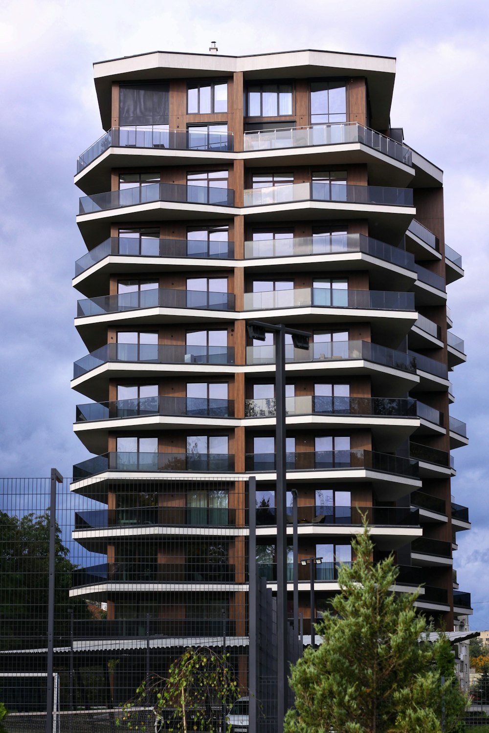 a tall building with many windows and balconies